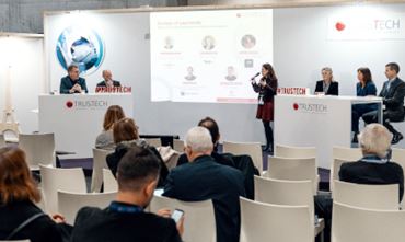 People attending a round table on Sovereignty regarding Europe of payments with 6 speakers in the TRUSTECH conference room