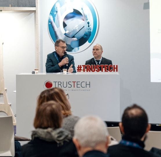 2 speakers sitting in front of attendees in the TRUSTECH conference room, talking about the European strategies of sovereignty in payment