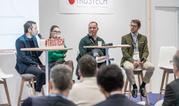 TRUSTECH 2025 panel discussion on Artificial intelligence and agentic commerce with multiple speakers on stage in front of attendees