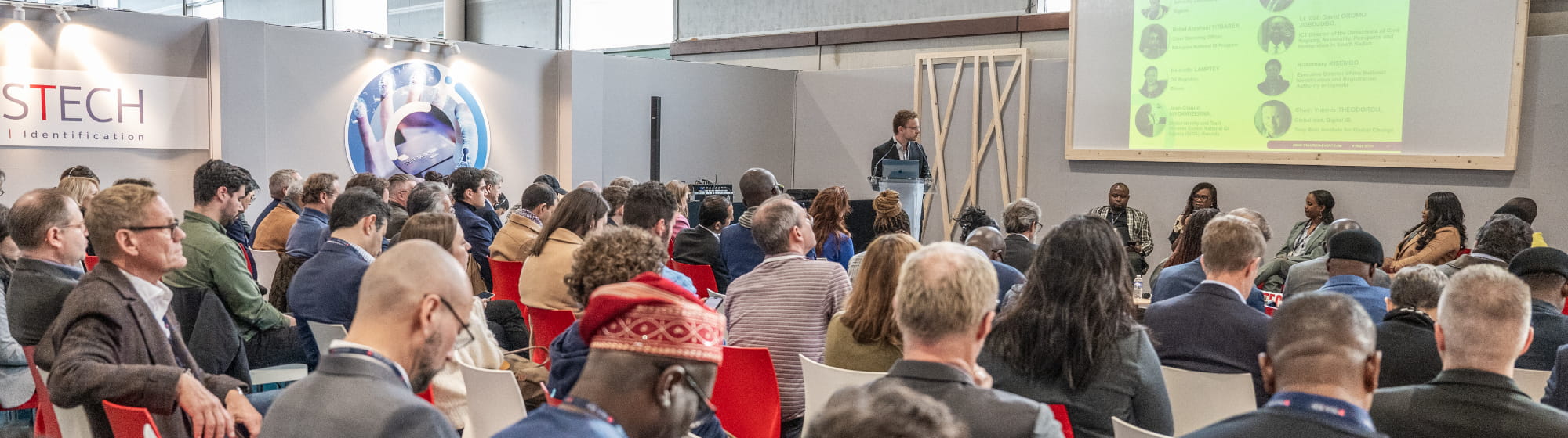Visitors attending a conference during TRUSTECH in a crowded conference room