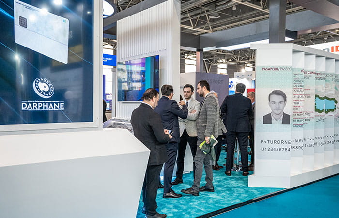 A group of professionales discuss at Darphane exhibition booth