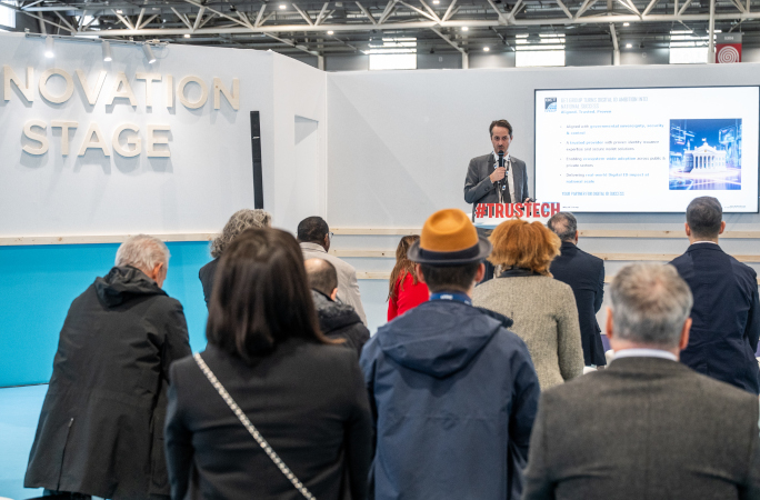 Conférence à TRUSTECH 2025 sur l’Innovation Stage avec un intervenant présentant devant une audience professionnelle