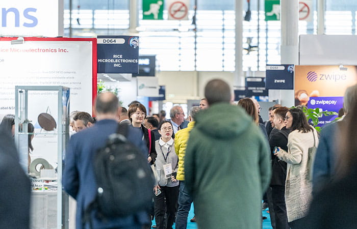 Visitors walking in trustech's aisles